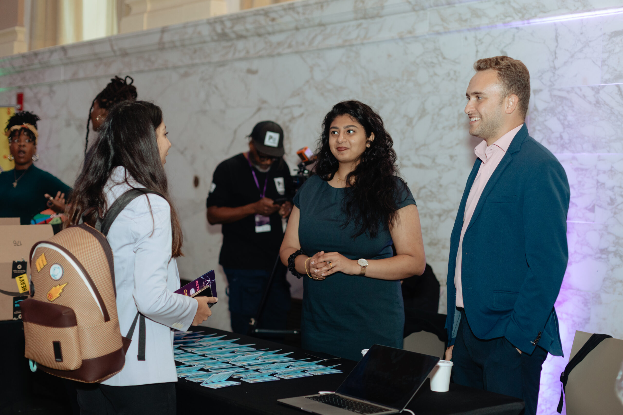 Two women speaking at a booth